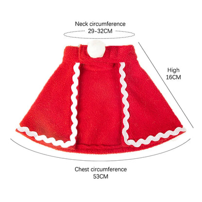 Adorable cat wearing reindeer antlers, Santa hat, red scarf, and holiday cloak for Christmas celebrations