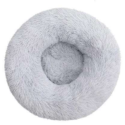 Ultra-soft round plush pet bed for cats and dogs, winter-ready with long plush fabric and non-slip base, available in sizes from 40cm to 90cm.
