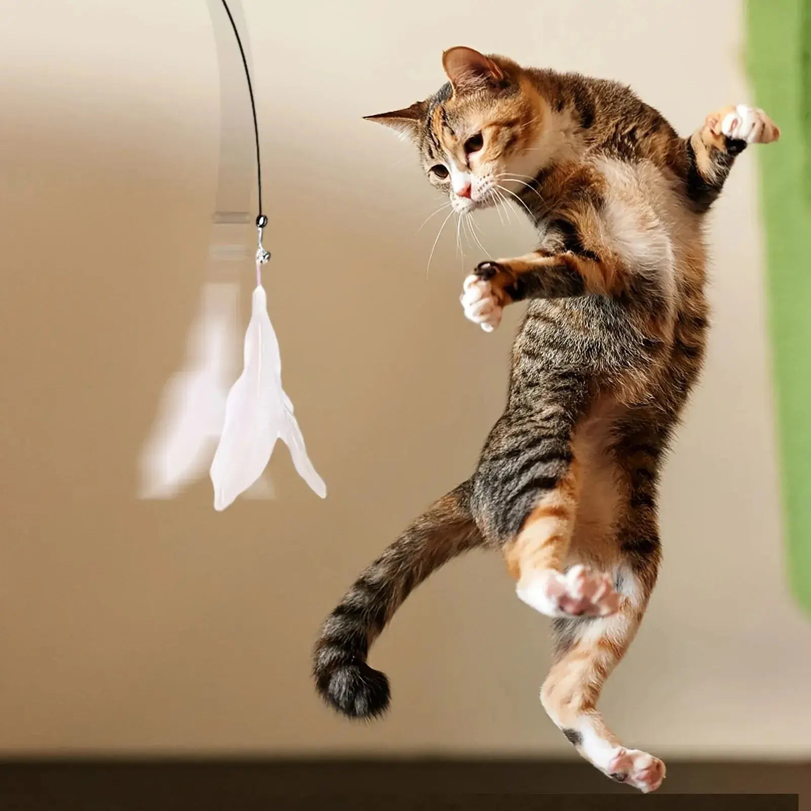 Interactive cat teaser toy with bell and feather wand, featuring a suction cup for exciting playtime adventures.