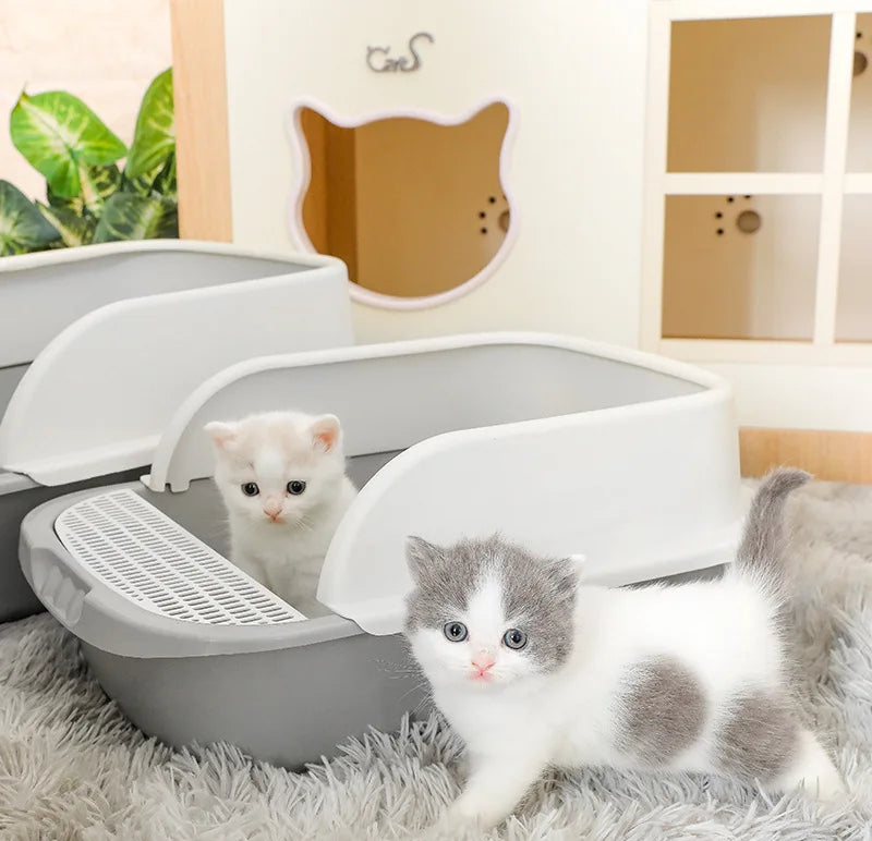 Large semi-enclosed cat litter box with high splash-guard border, available in blue, grey, and pink, designed for easy cleaning and odor control.