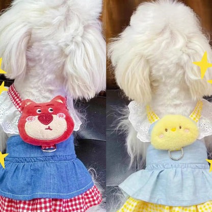 Small dog wearing pink doll-style harness with denim skirt and matching leash
