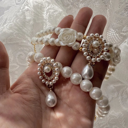 Small dog wearing antique pearl floral necklace with zircon accents