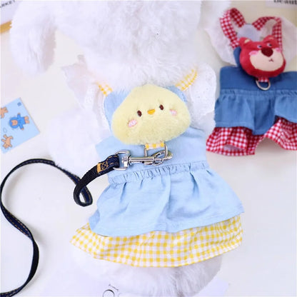 Small dog wearing pink doll-style harness with denim skirt and matching leash