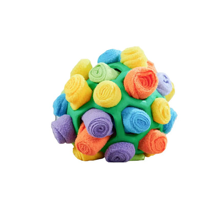 Dog playing with an interactive rubber sniffing ball filled with treats.