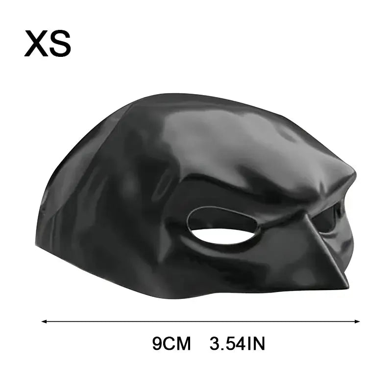 Cat wearing a black bat-inspired superhero mask, posing confidently for Halloween.