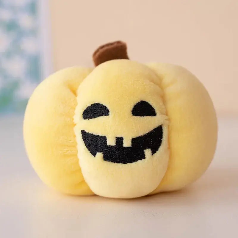 Small dog cuddling a Halloween pumpkin plush toy with night light.