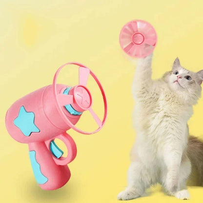 Cat jumping to catch a flying disc launched by interactive cat toy
