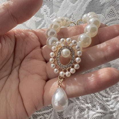 Small dog wearing antique pearl floral necklace with zircon accents