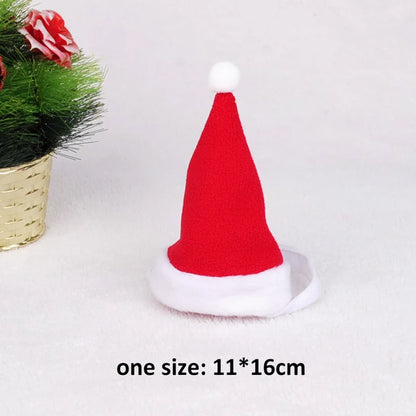 Adorable cat wearing reindeer antlers, Santa hat, red scarf, and holiday cloak for Christmas celebrations