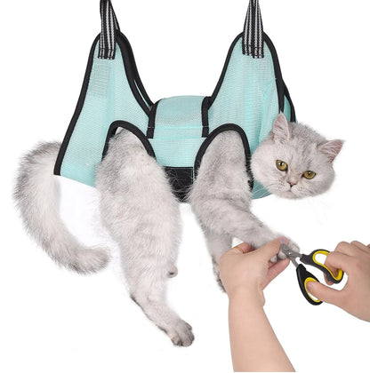 Cat suspended in a grooming hammock while getting its nails trimmed, safe and stress-free grooming tool