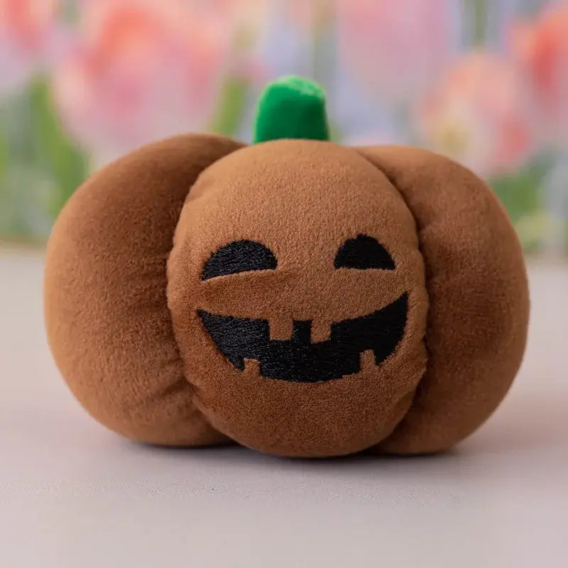 Small dog cuddling a Halloween pumpkin plush toy with night light.