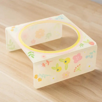 Flower-shaped ceramic pet bowl with clear acrylic stand for cats and dogs.
