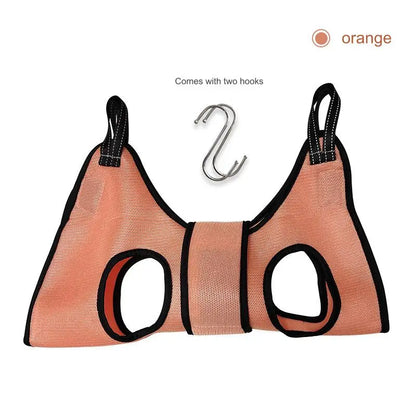 Cat suspended in a grooming hammock while getting its nails trimmed, safe and stress-free grooming tool