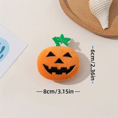 Dog chewing on a Halloween pumpkin ghost face toy.