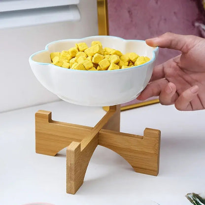 Cat paw-shaped ceramic pet bowl with bamboo stand, perfect for cats and dogs.