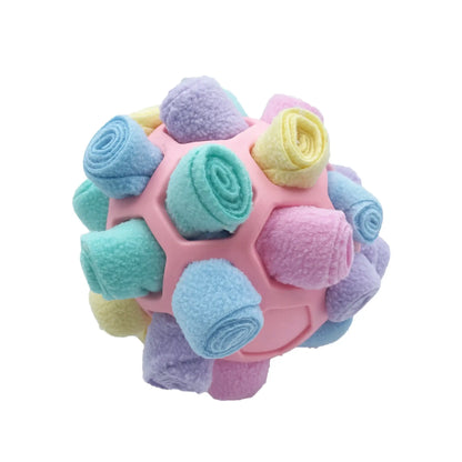 Dog playing with an interactive rubber sniffing ball filled with treats.