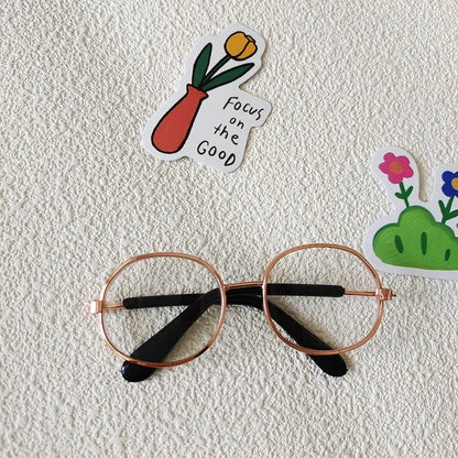 Small dog wearing round wizard cosplay glasses inspired by Harry Potter