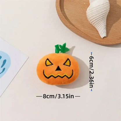 Dog chewing on a Halloween pumpkin ghost face toy.