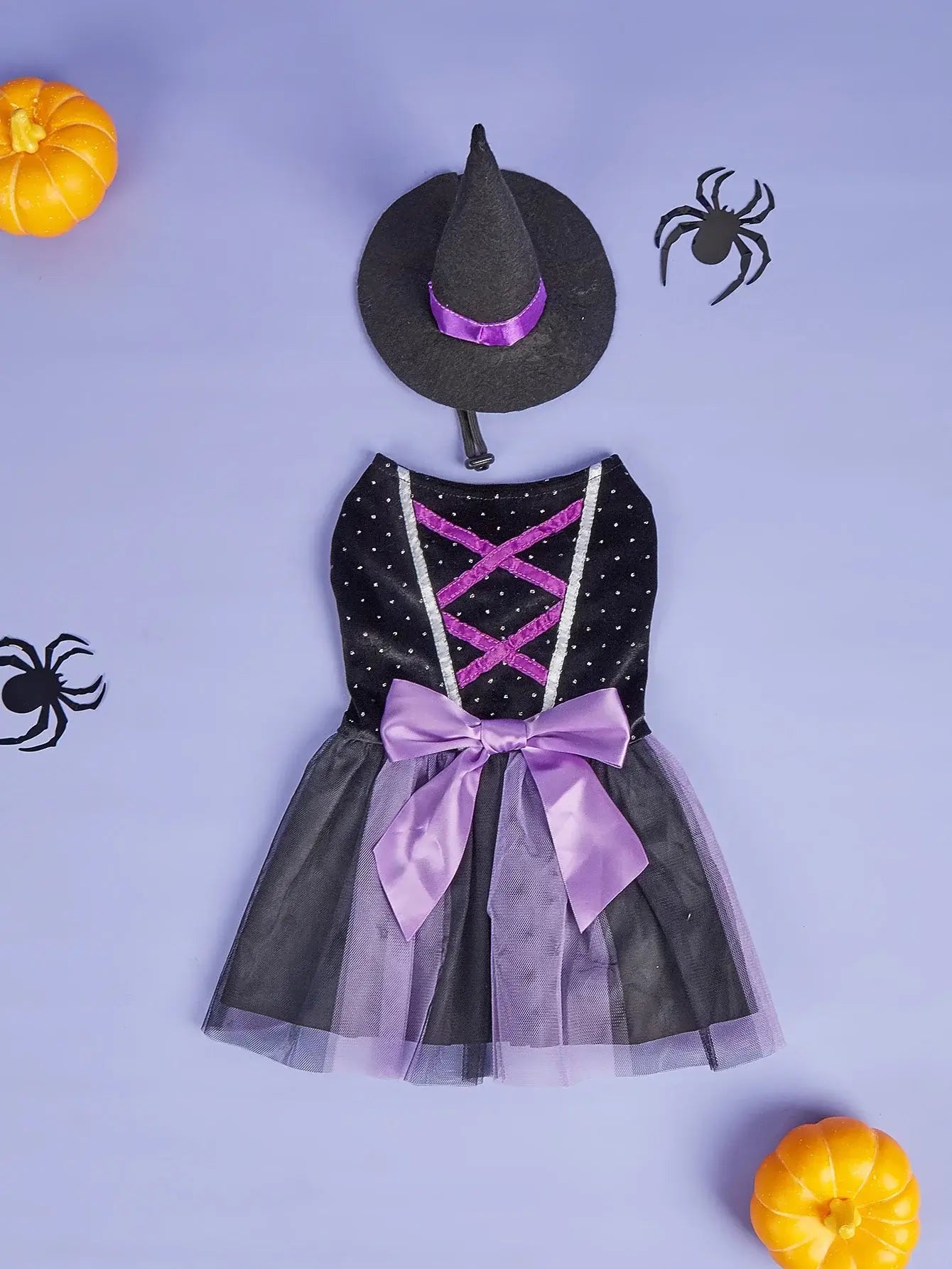 Small dog wearing velvet Halloween dog dress with tulle tutu and witch hat, perfect for Halloween parties or pet photoshoots.