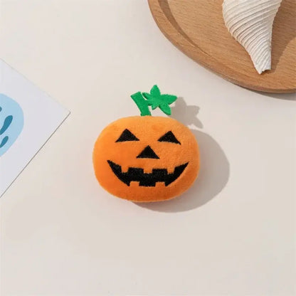 Dog chewing on a Halloween pumpkin ghost face toy.