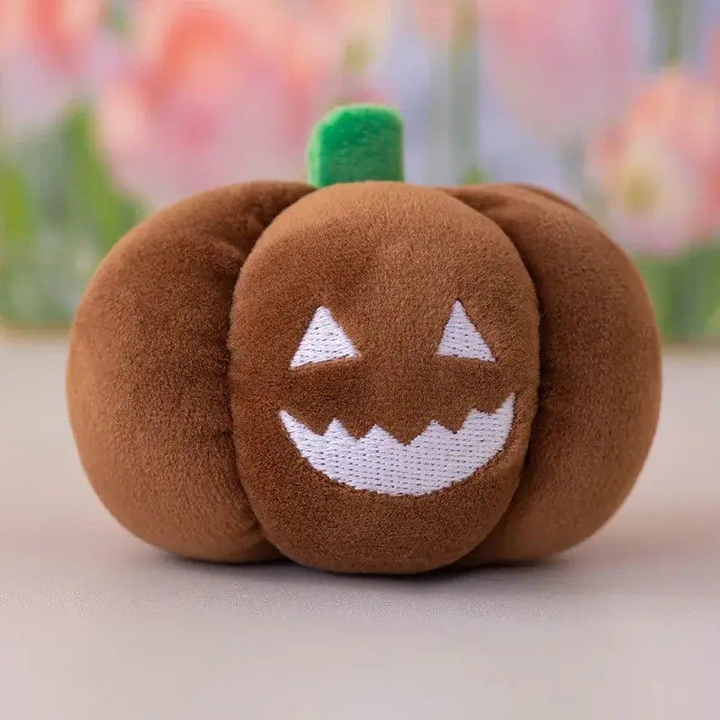 Small dog cuddling a Halloween pumpkin plush toy with night light.