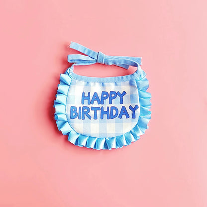 Small dog wearing birthday scarf and hat set for celebration or party