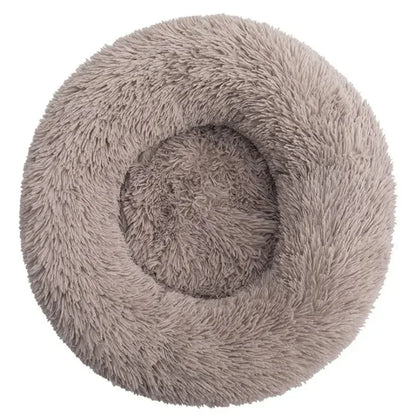 Ultra-soft round plush pet bed for cats and dogs, winter-ready with long plush fabric and non-slip base, available in sizes from 40cm to 90cm.