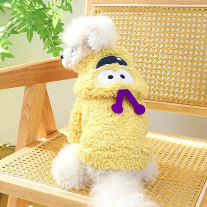 Small dog wearing a thick plush Halloween hoodie coat for chilly weather.