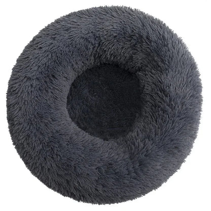 Ultra-soft round plush pet bed for cats and dogs, winter-ready with long plush fabric and non-slip base, available in sizes from 40cm to 90cm.
