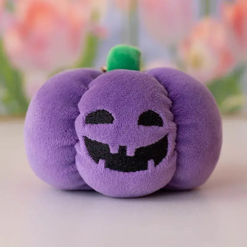 Small dog cuddling a Halloween pumpkin plush toy with night light.