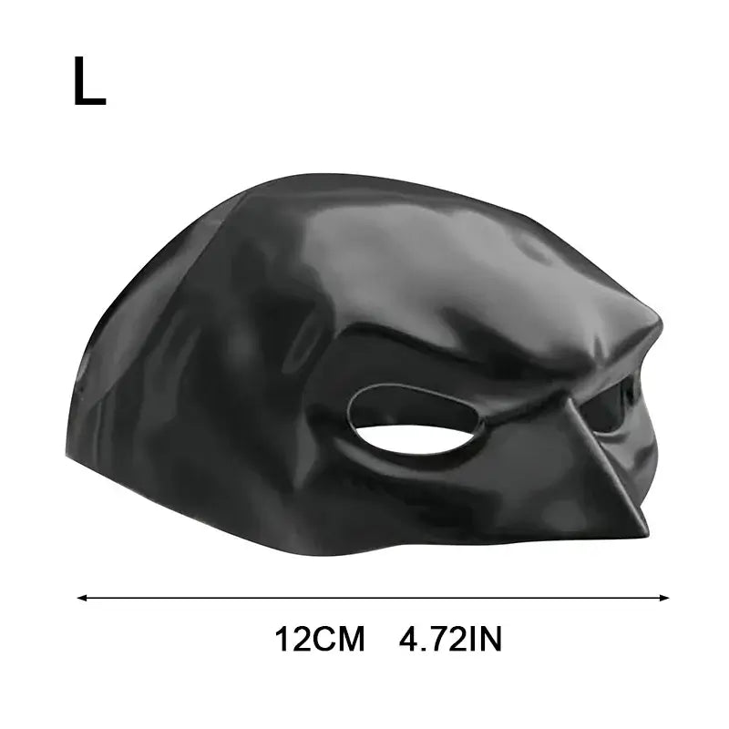 Cat wearing a black bat-inspired superhero mask, posing confidently for Halloween.